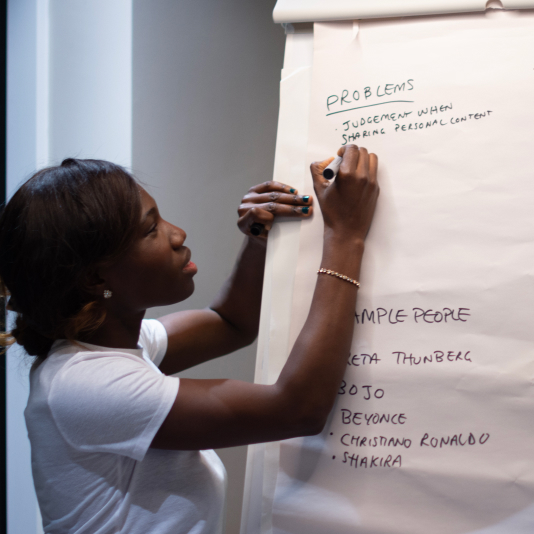 Attendee writing on whiteboard