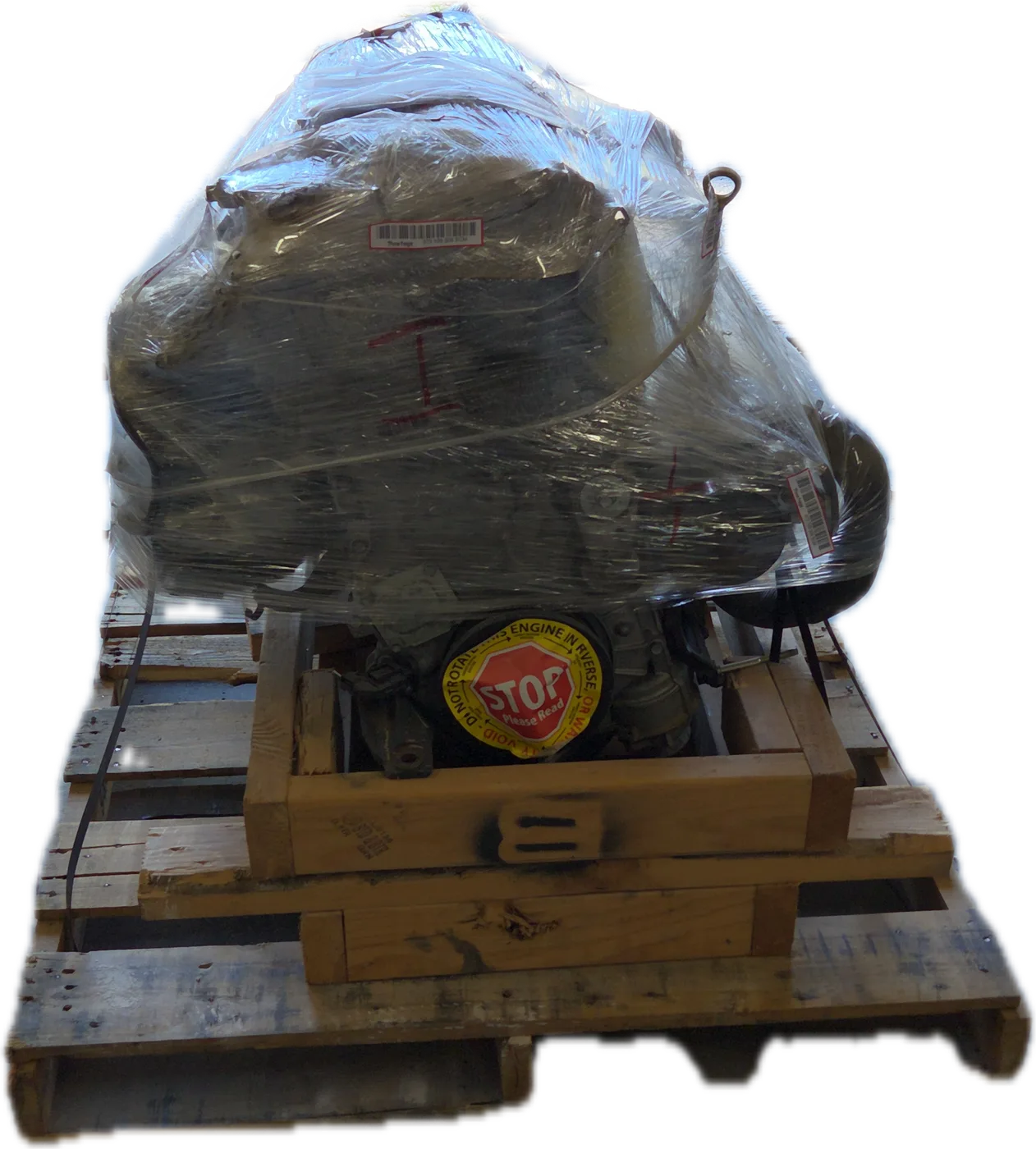 A replacement engine wrapped in plastic on a wooden pallet