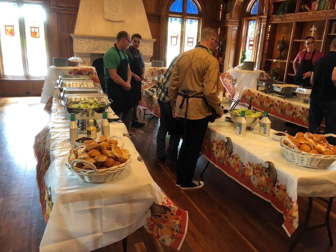 Volunteers serving Thanksgiving dinner inside Chateau de Vie