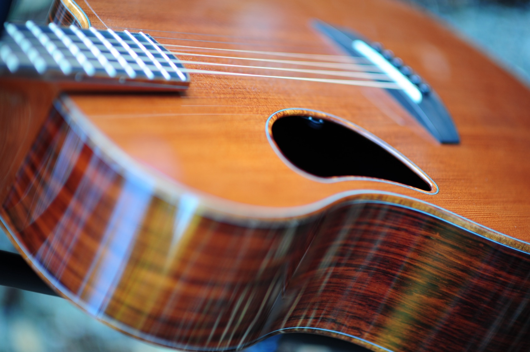 Detail of the McPherson's offset soundhole, redwood top, and figured side