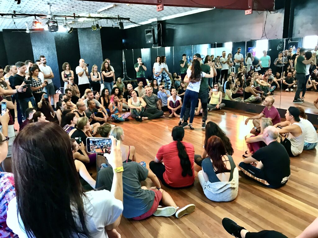Partner dance demonstration in a mirror-walled studio at The Space