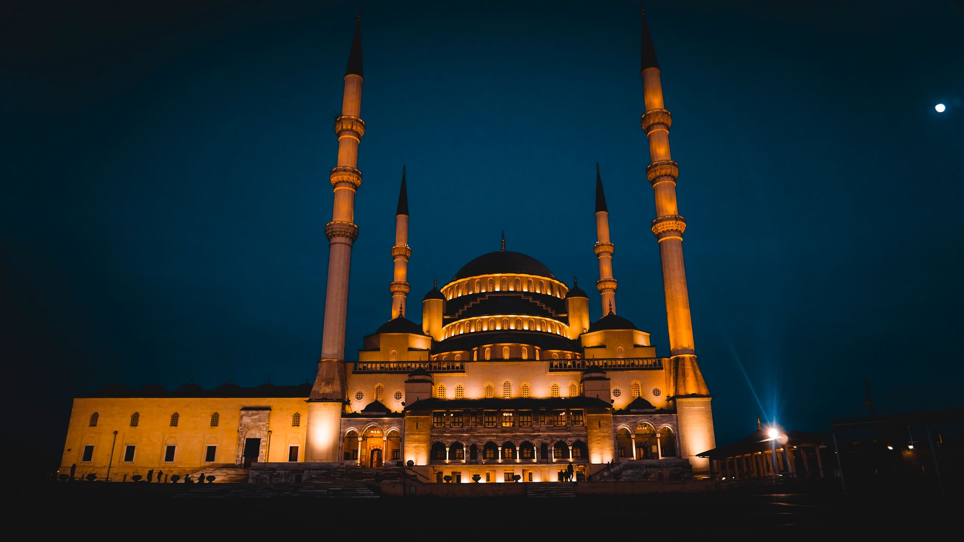 A modern mosque exterior at golden hour, welcoming all who enter.