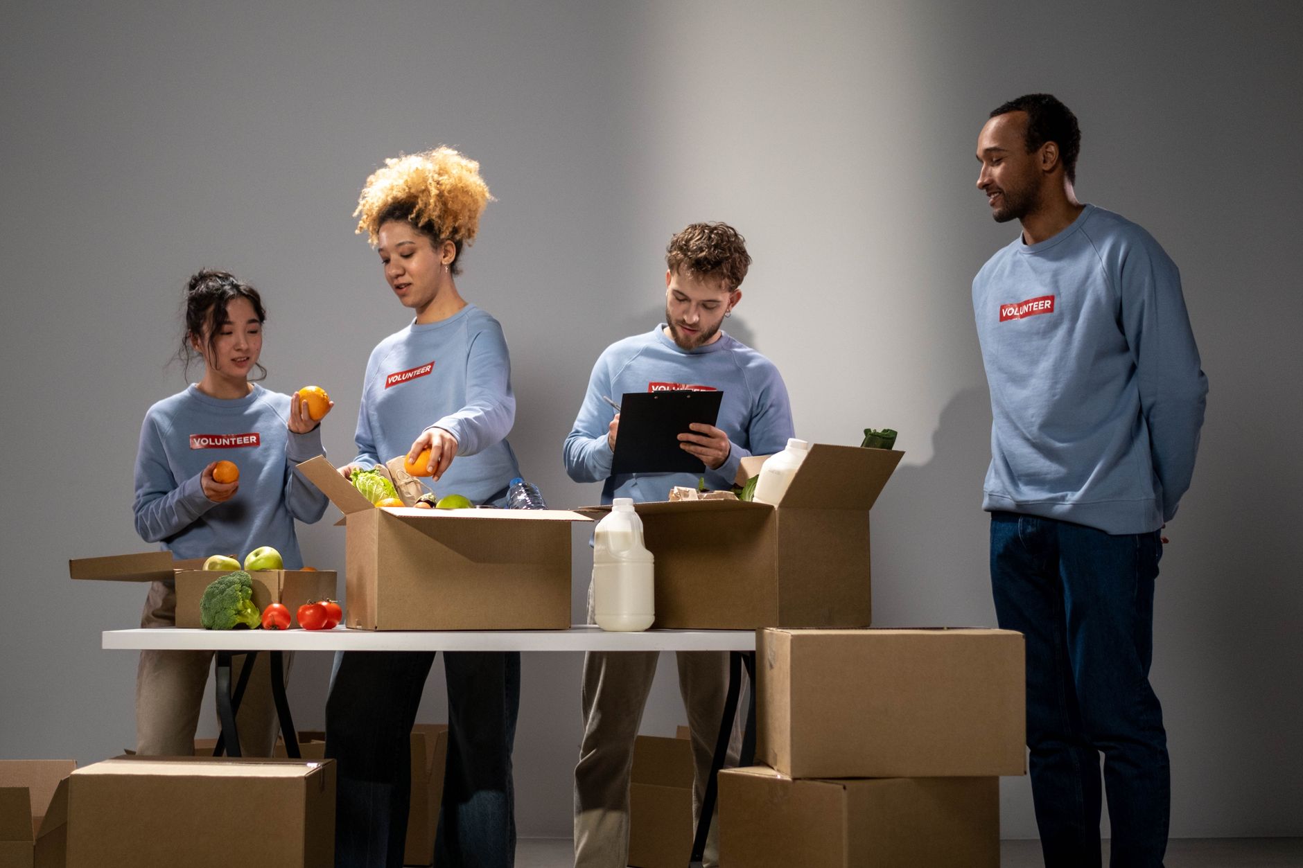 Volunteers packing grocery boxes at a community food pantry.