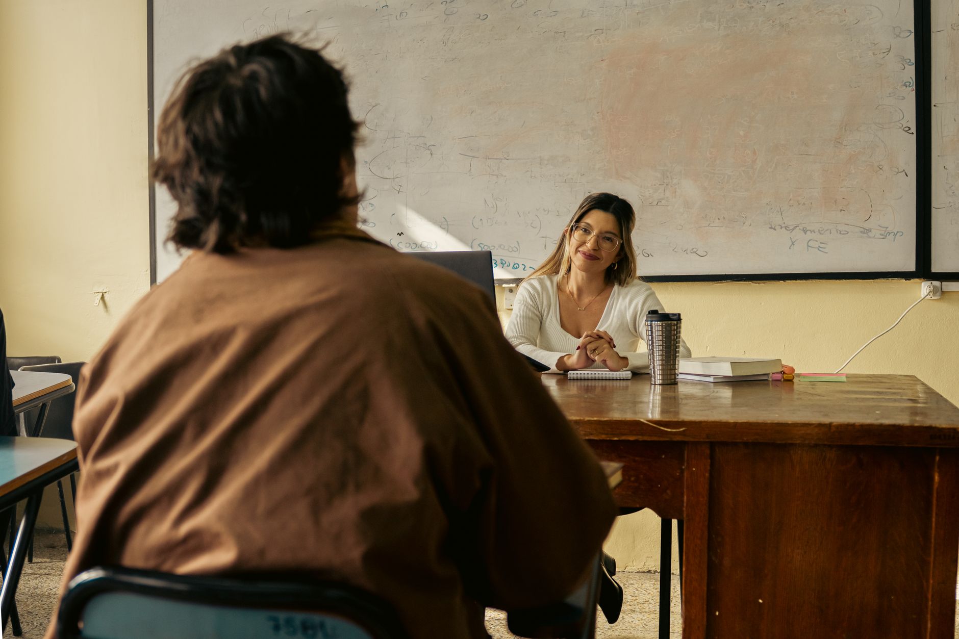 A community teacher working one-on-one with a learner.