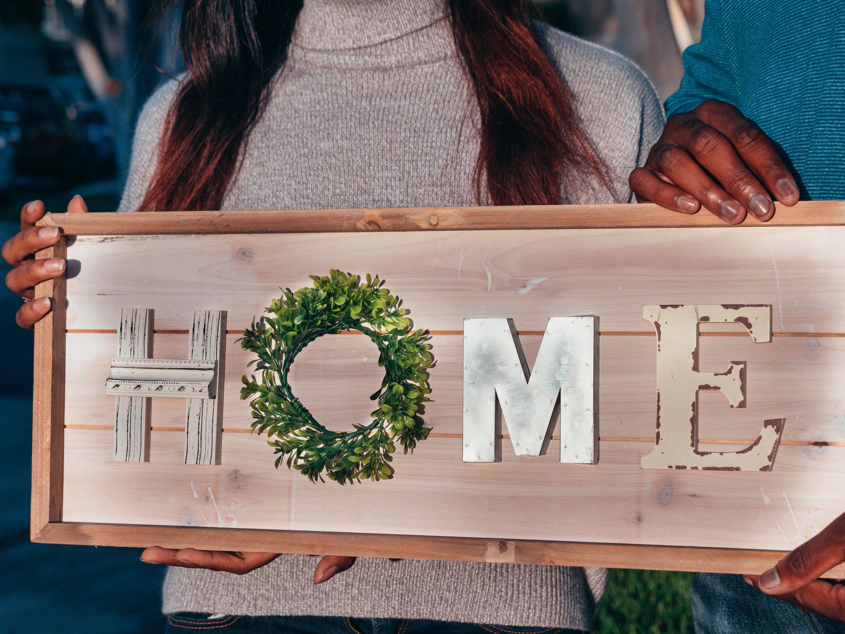 A new family welcomed into a community home, surrounded by volunteers.