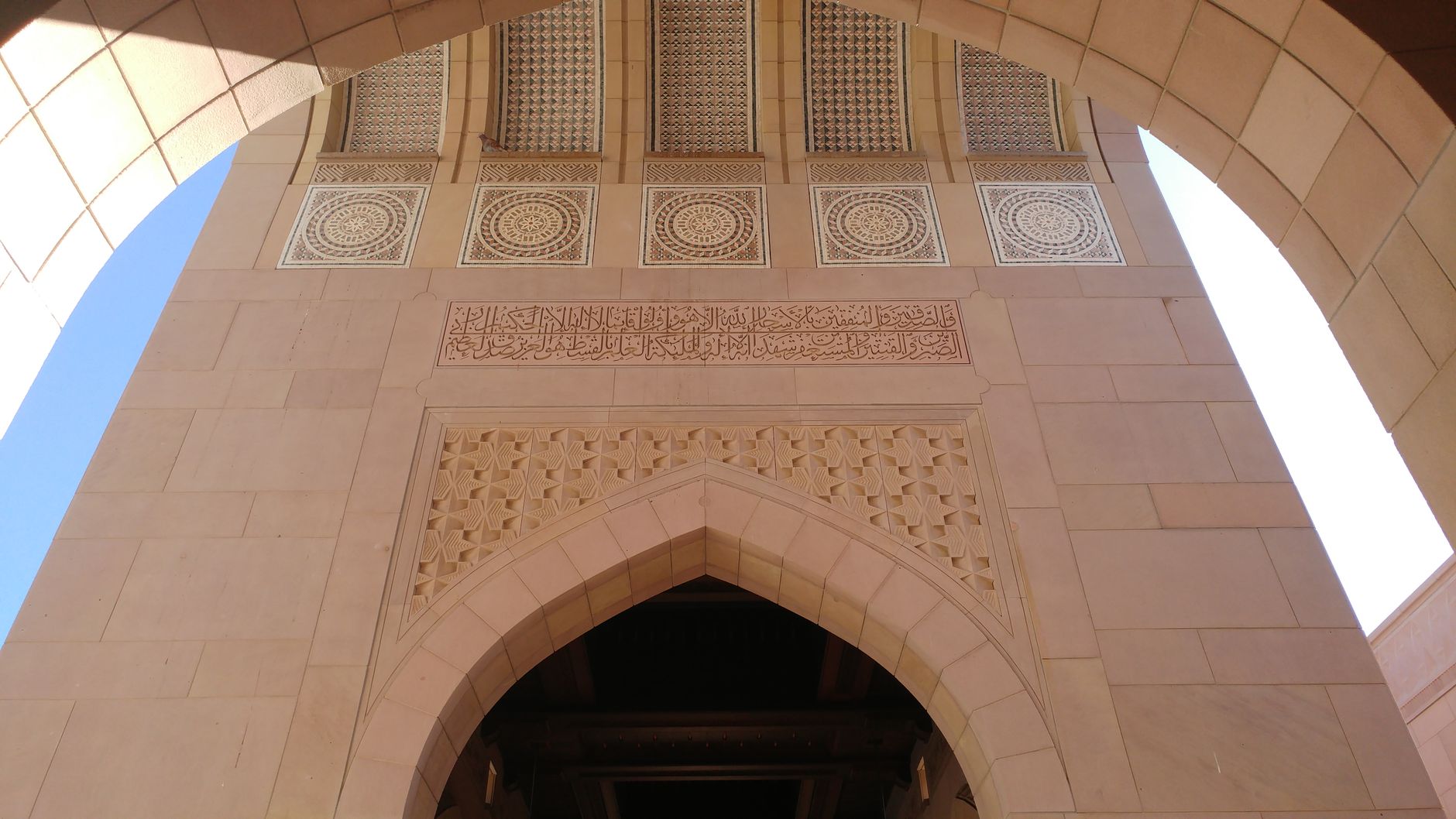 A close-up of a geometric arch pattern, soft warm light.