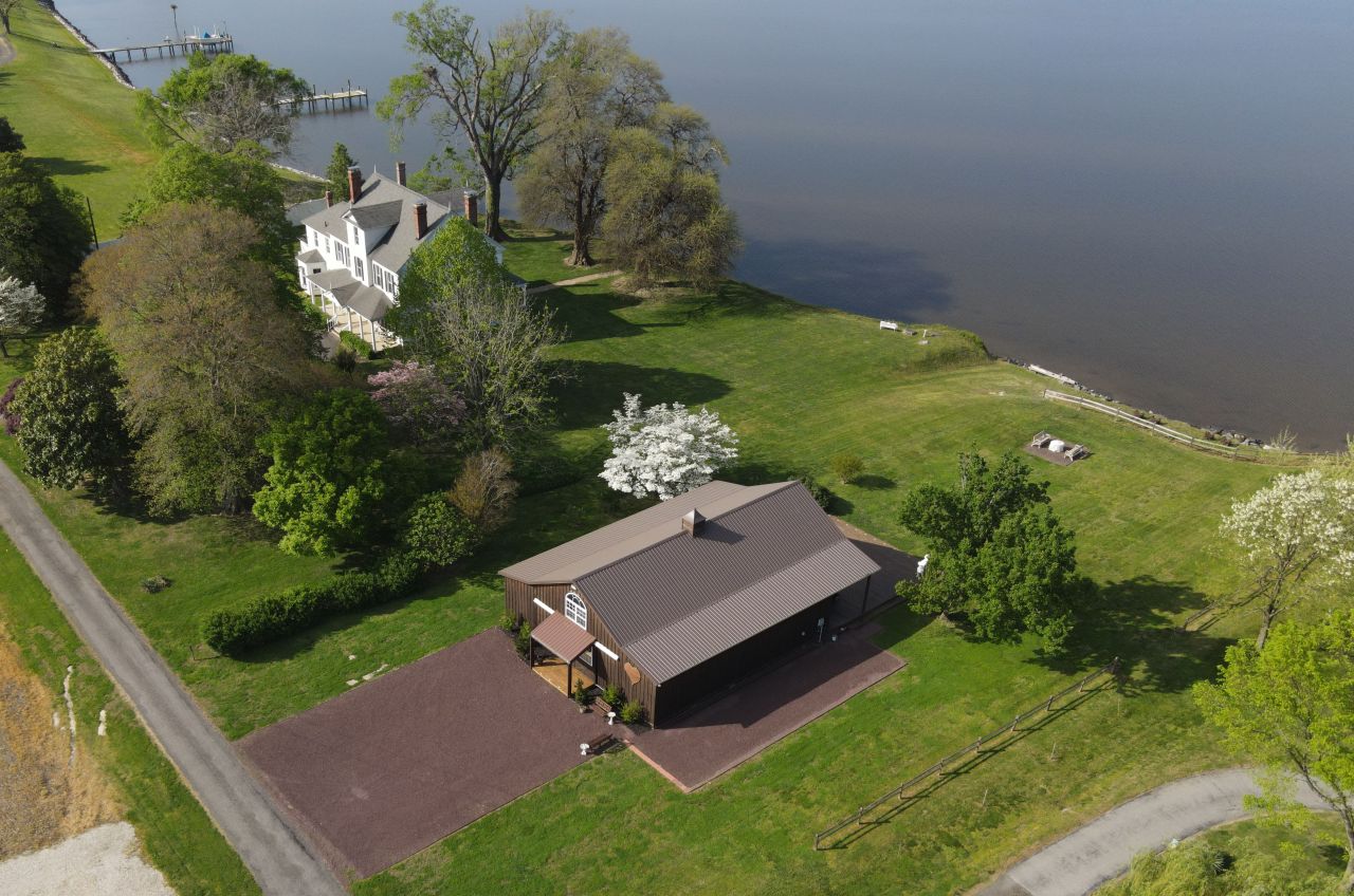 An aerial view of the Reception Barn, Manor House, and Wicomico River