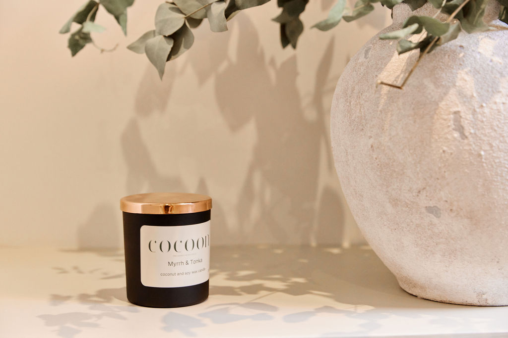 Cocoon branded wellness products with natural eucalyptus arrangement