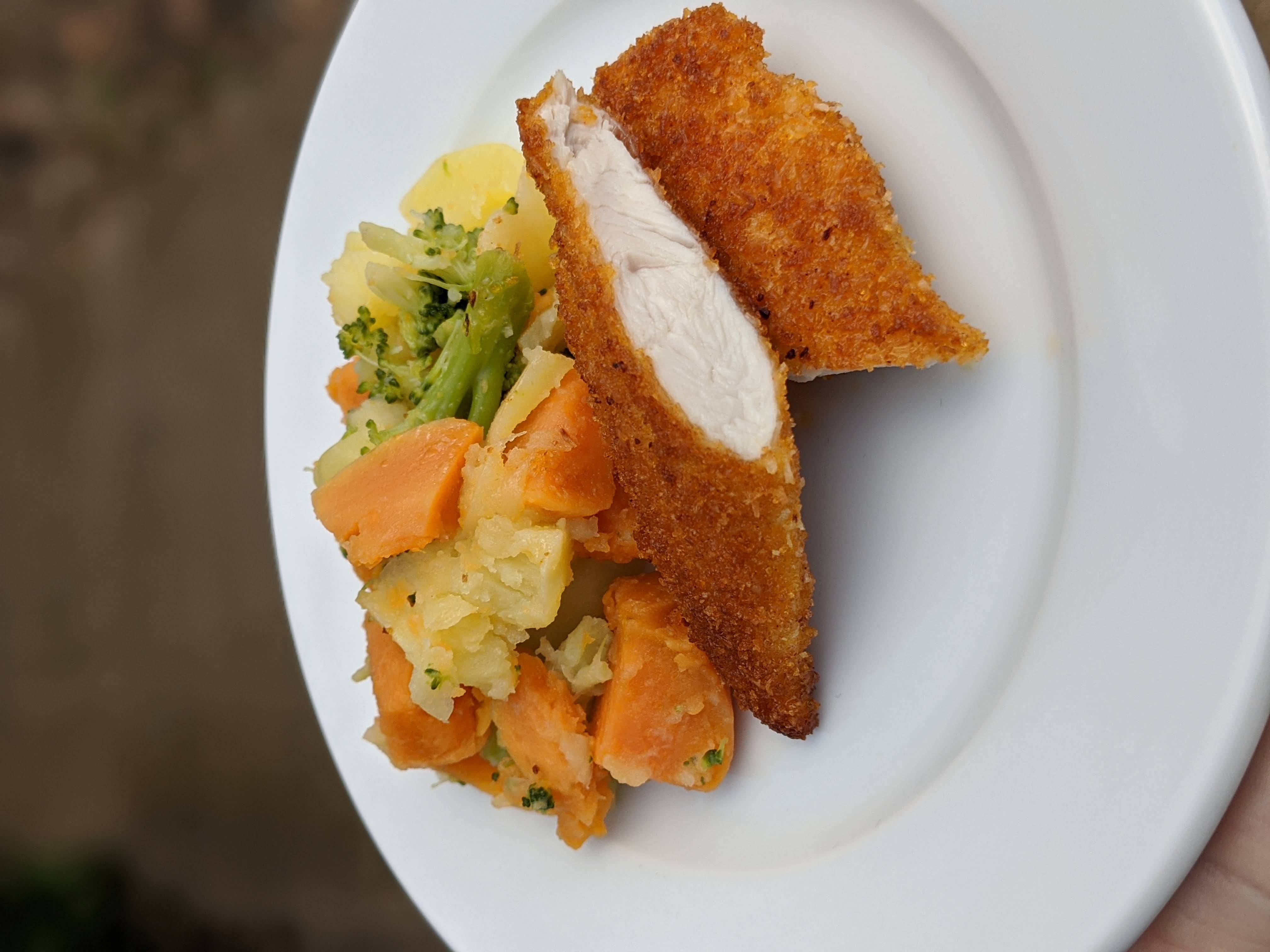 Coconut Crusted Chicken Schnitzel Served with Vegetable Mash