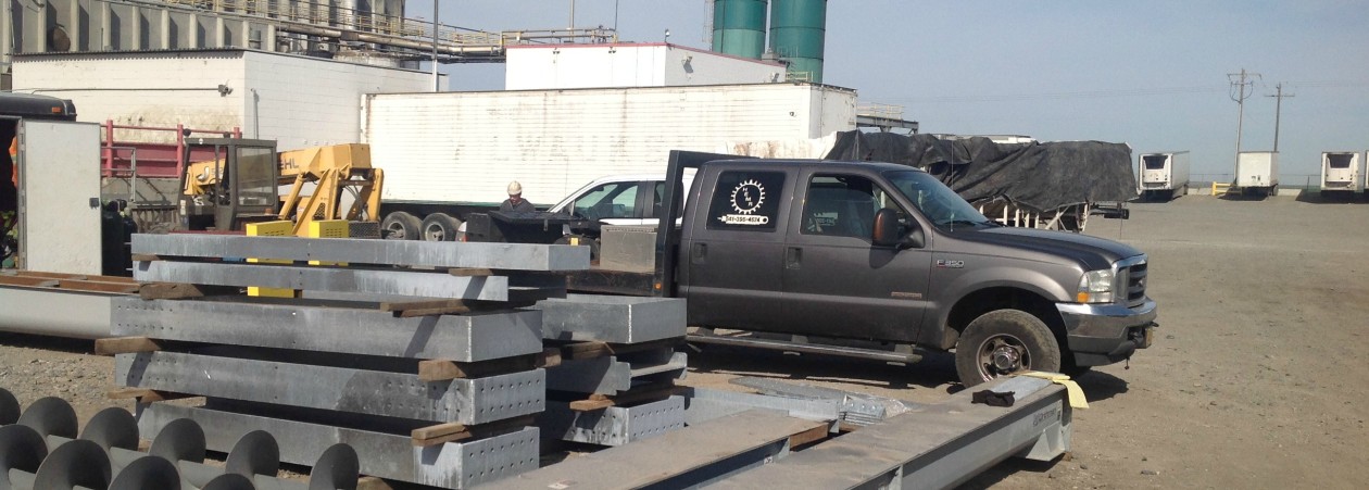 A HEMR Industrial work truck and fabricated steel at an industrial plant site.