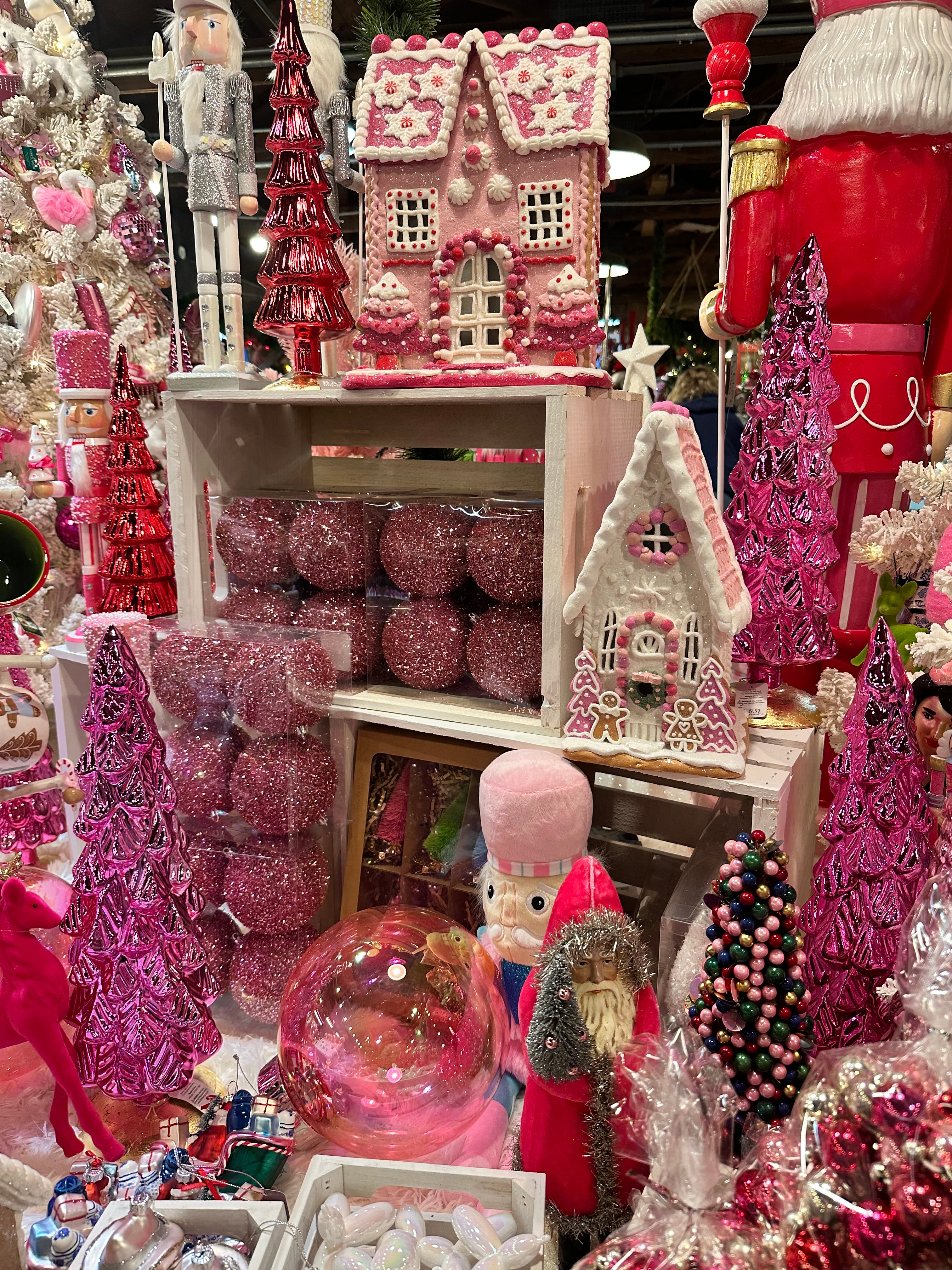 Pink gingerbread houses, ornaments, and Christmas decorations inside The Summit Gingerbread Shoppe