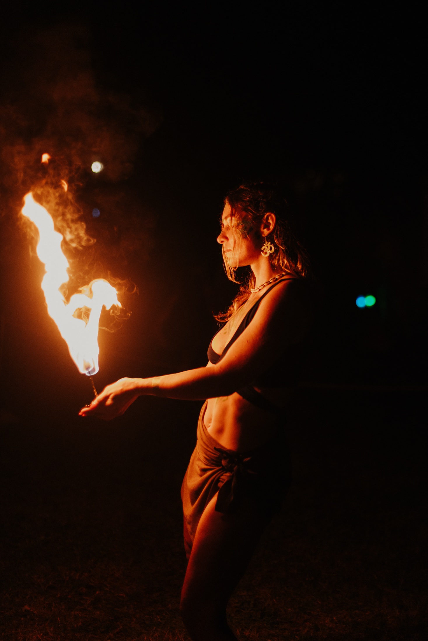 Symbiotica performer dancing beside a flame