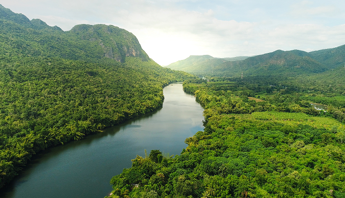 beautiful river in the middle of green fields and mountains