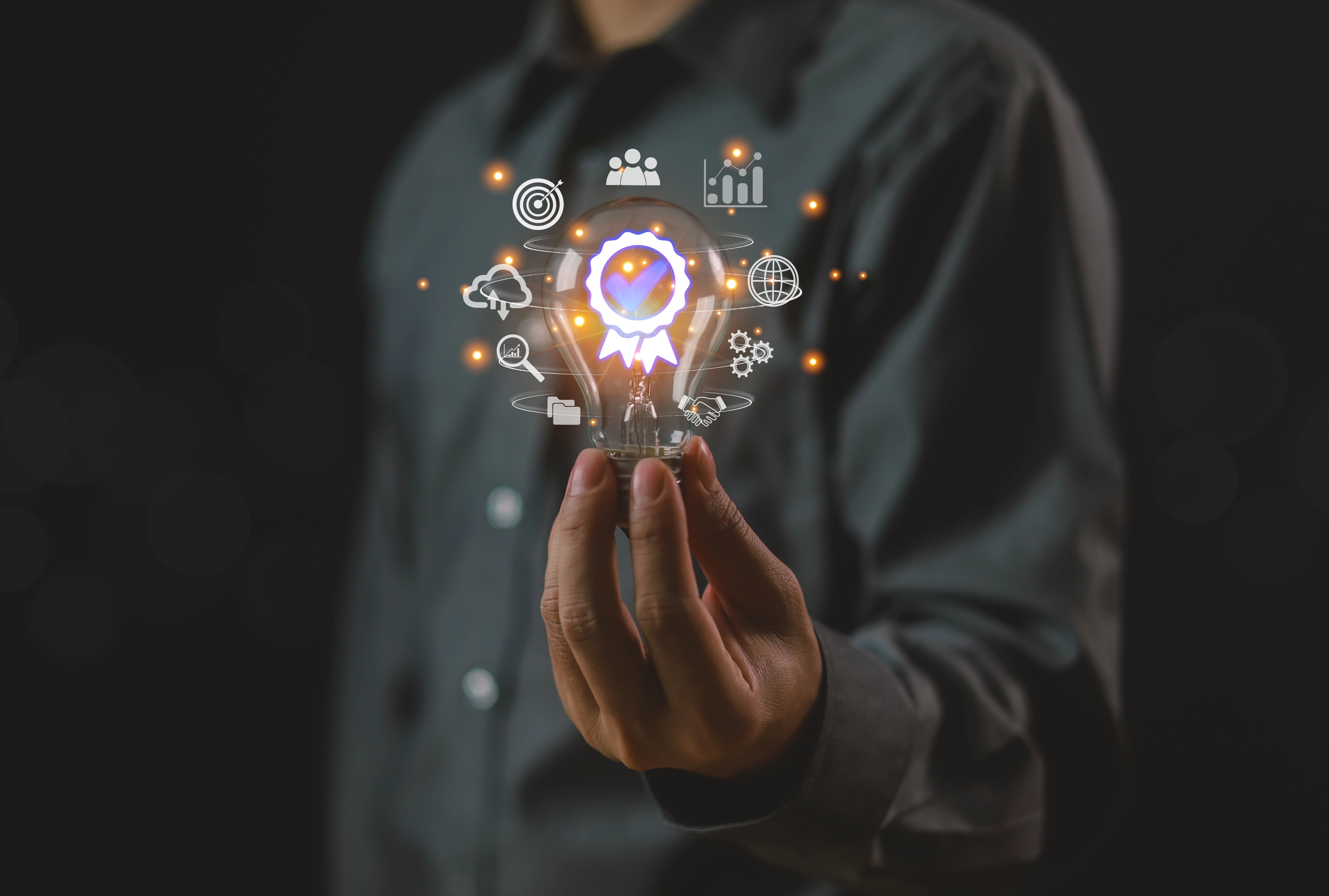 man holding a bulb with virtual images of data 