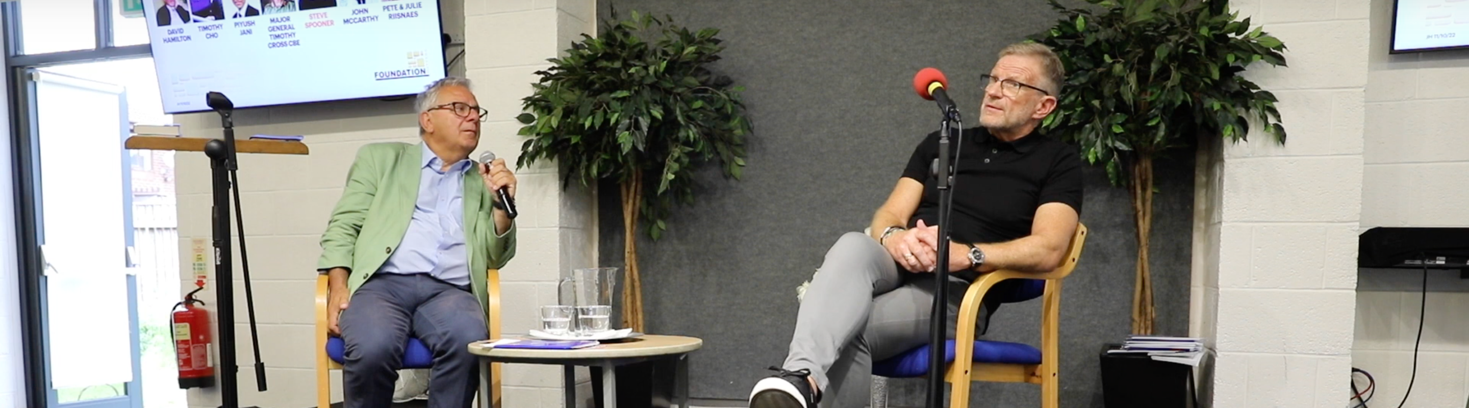 Roger Carswell and Steve Spooner chatting on stage at Stenson Fields Christian Fellowship