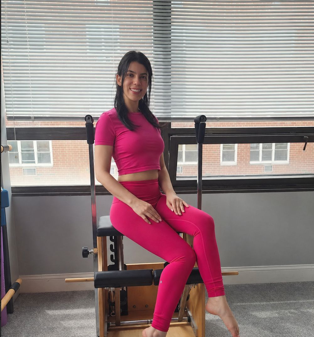 Isabela Gagliardo sitting on a Pilates chair