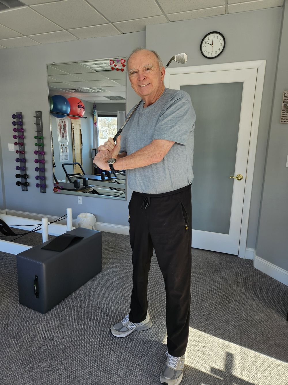 Guy Carroll practicing a golf swing in the studio