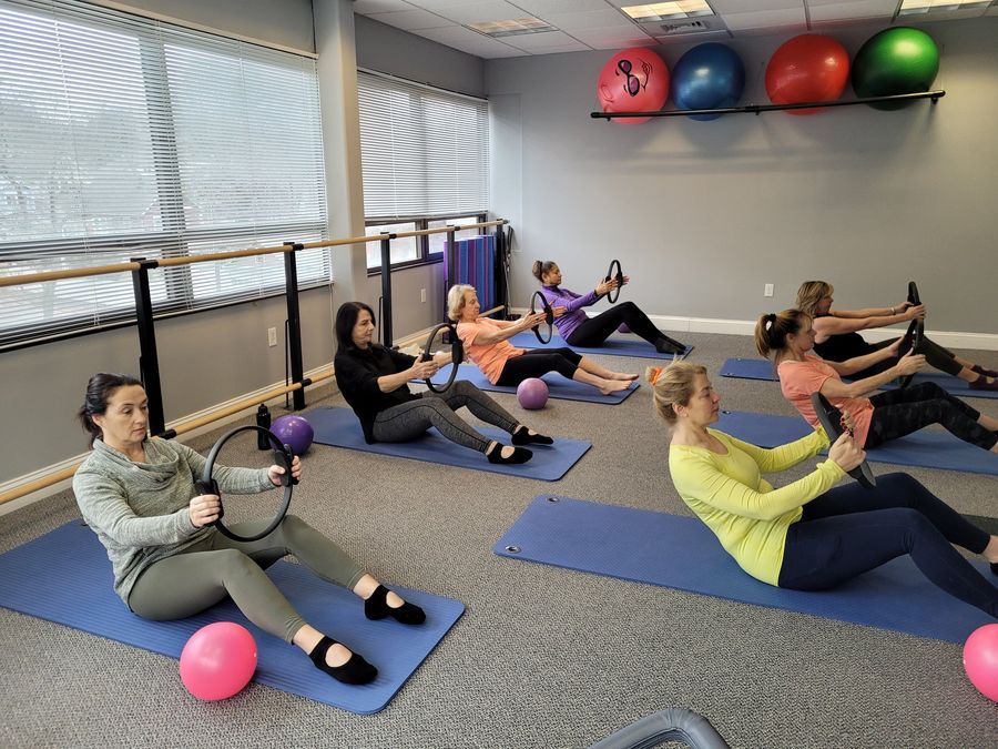 A small mat Pilates class using balls and rings