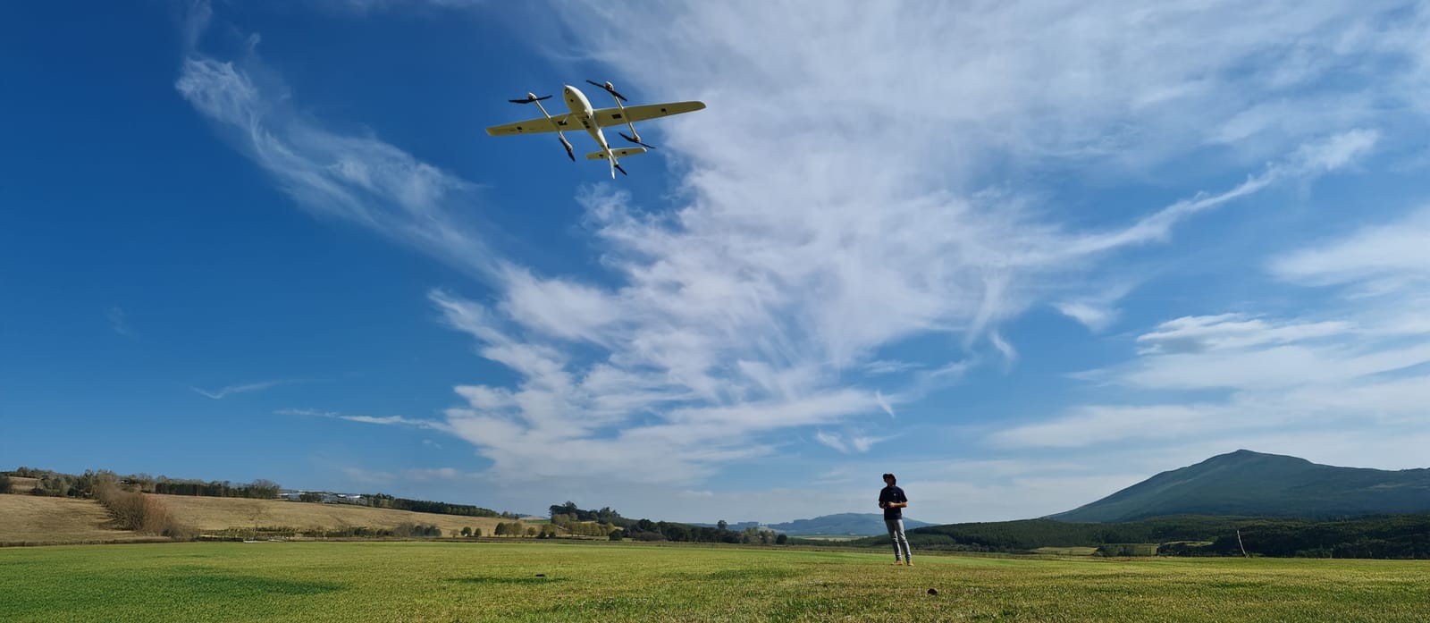 VTOL aerial survey drone flying over farmland