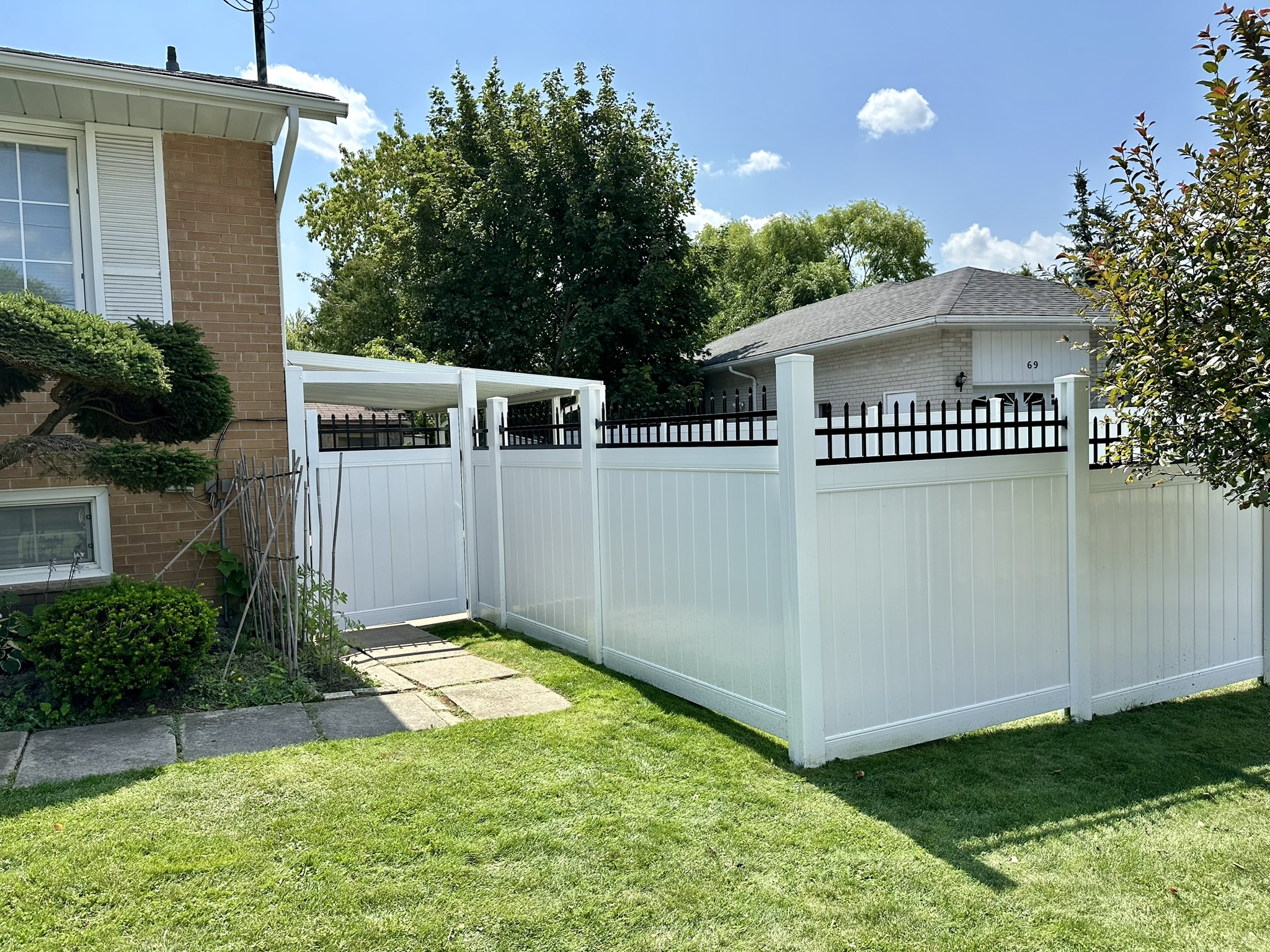 White vinyl fence in front of house Ontario