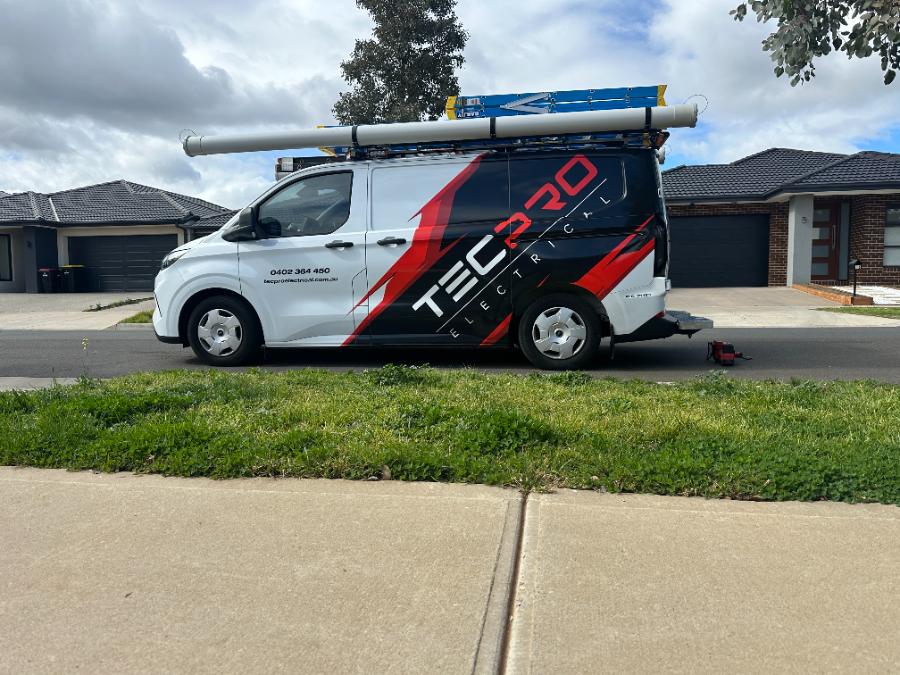 Tecpro Electrical van with red and black wrap on site in Melbourne