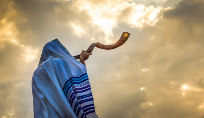 man blowing shofar