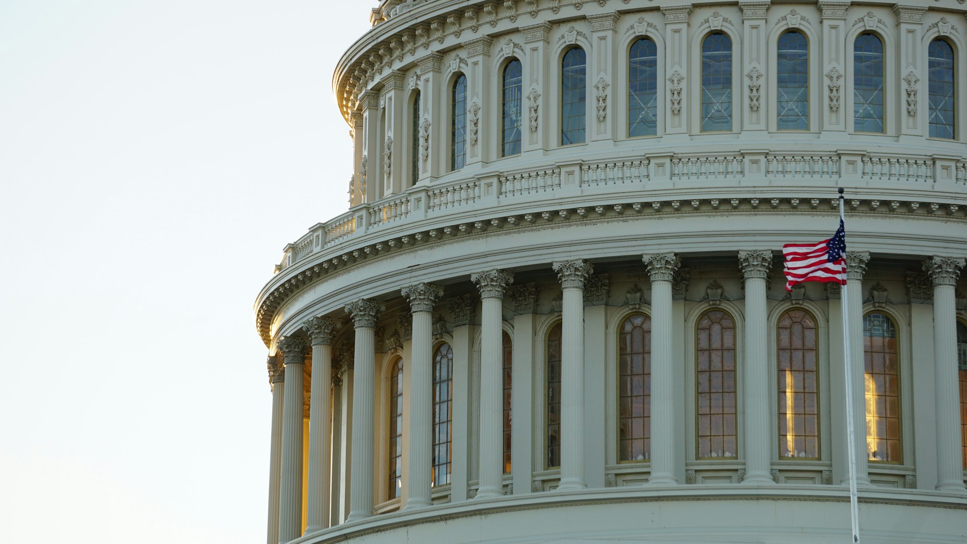 Close-up of the U.S. Capitol dome with an American flag