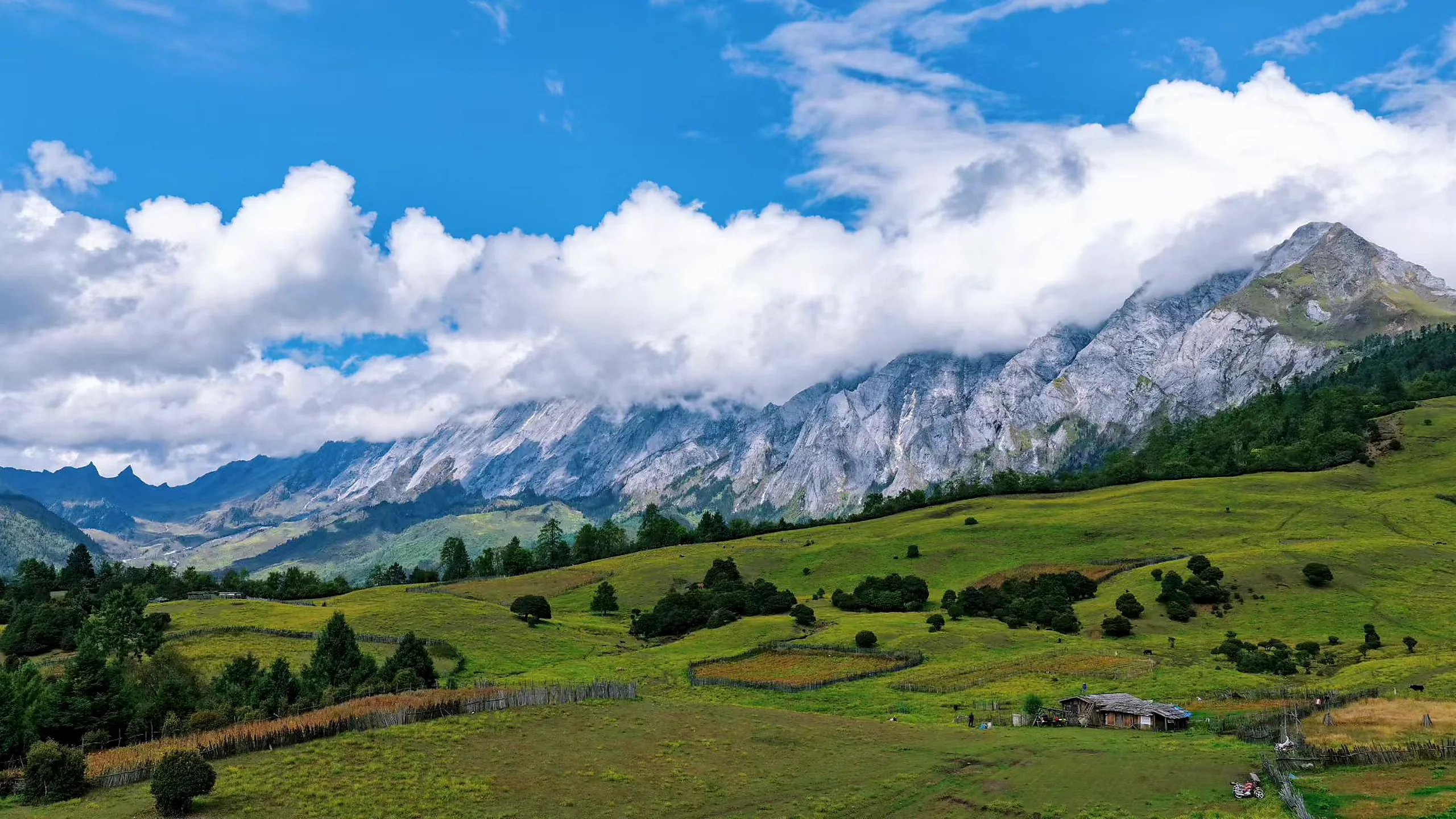High-country meadow and mountain ridges at Laoyao Mountain in Yunnan