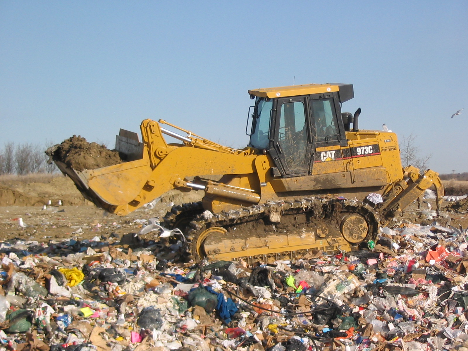 dozer pushing waste at landfill