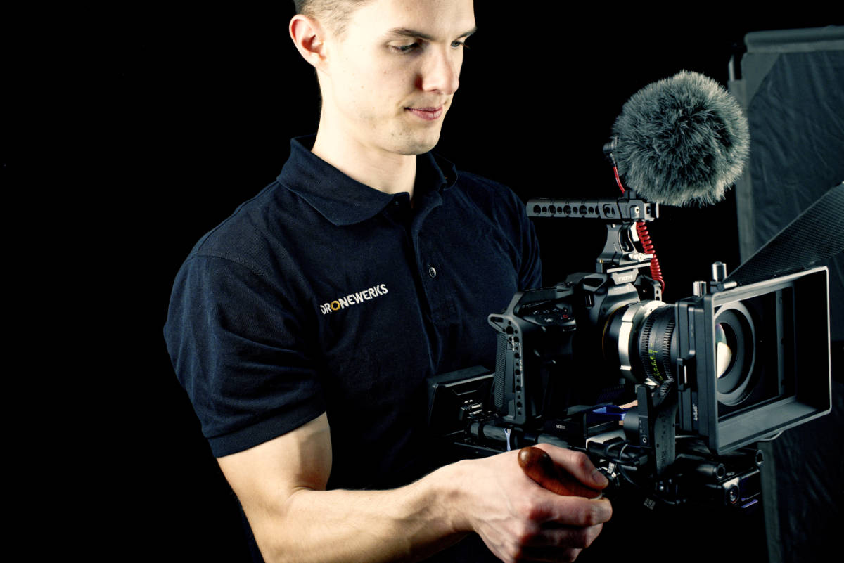 Guy holding cinema camera