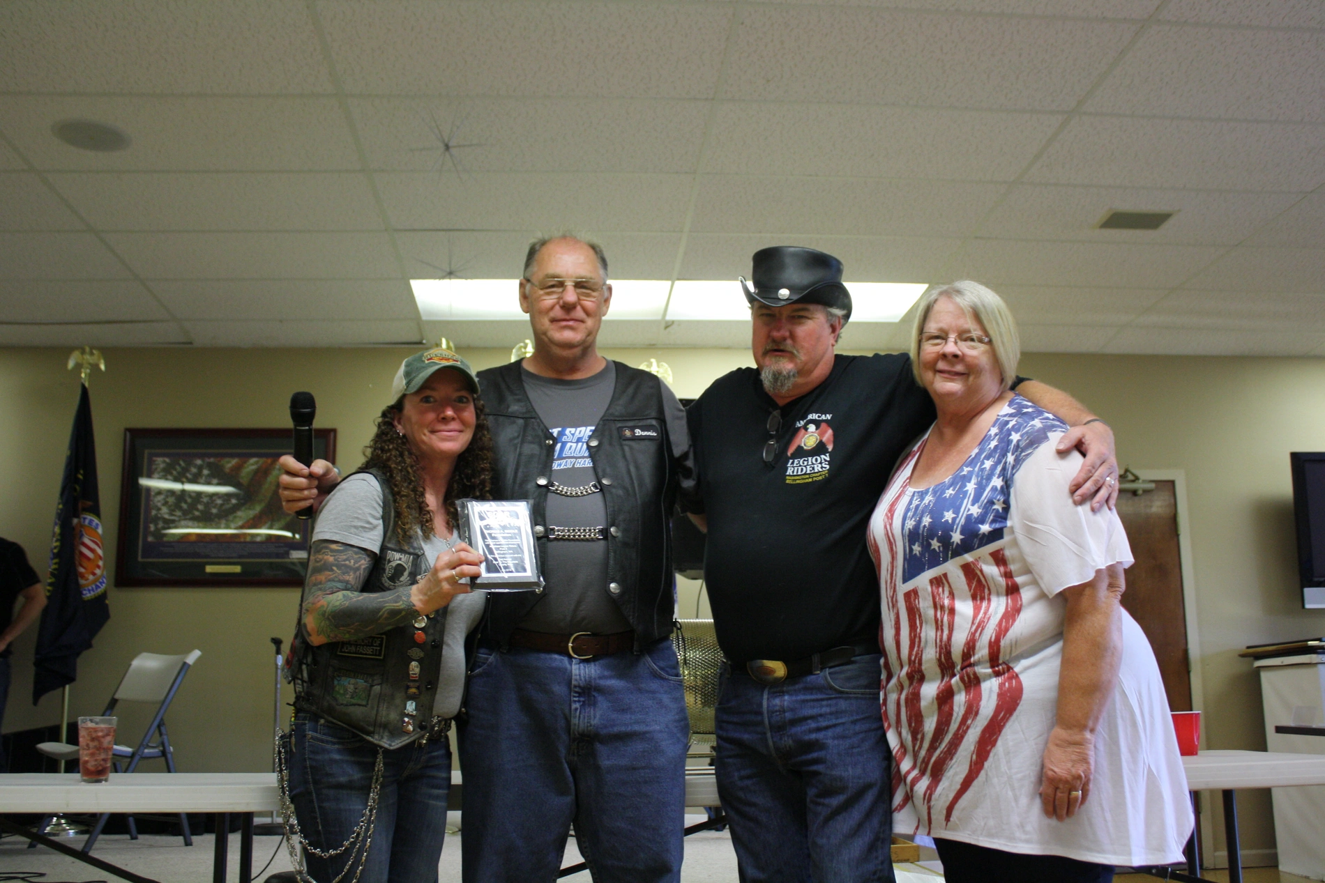 A collage of people at a Thomas A. Biddle Foundation motorcycle gathering, featuring group photos indoors, several motorcycles parked outdoors, and two people holding a plaque and a plate of patches at the event.