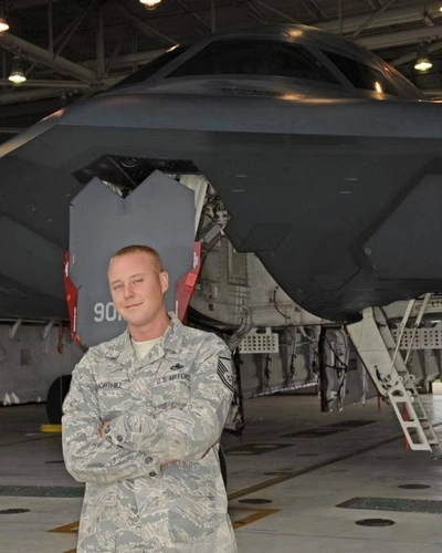 Jerred posing next to an aircraft