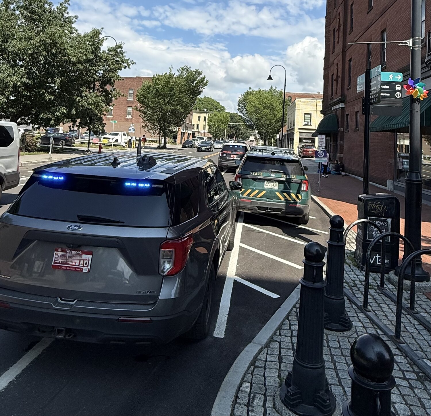 Burlington police and Vermont State Police vehicles parked with lights on near the Church Street Marketplace